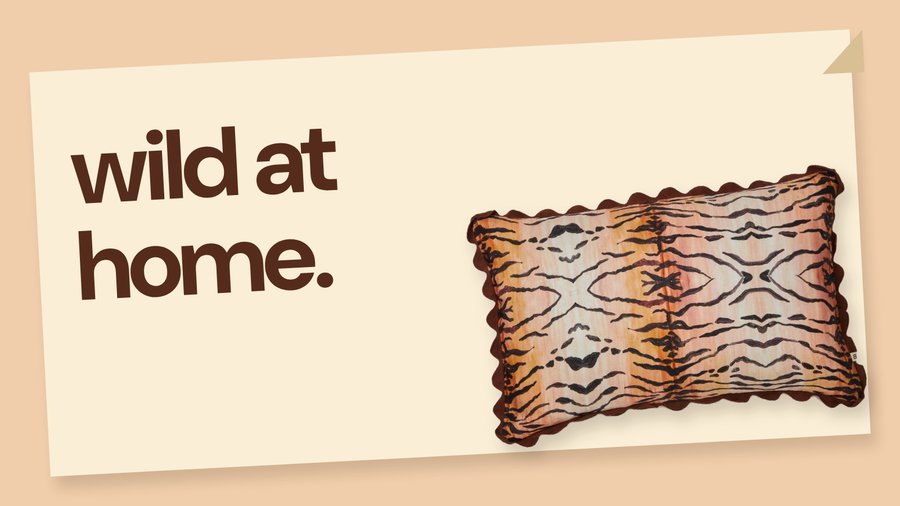 New arrivals example: a tiger print cushion and folded throw styled as a room vignette